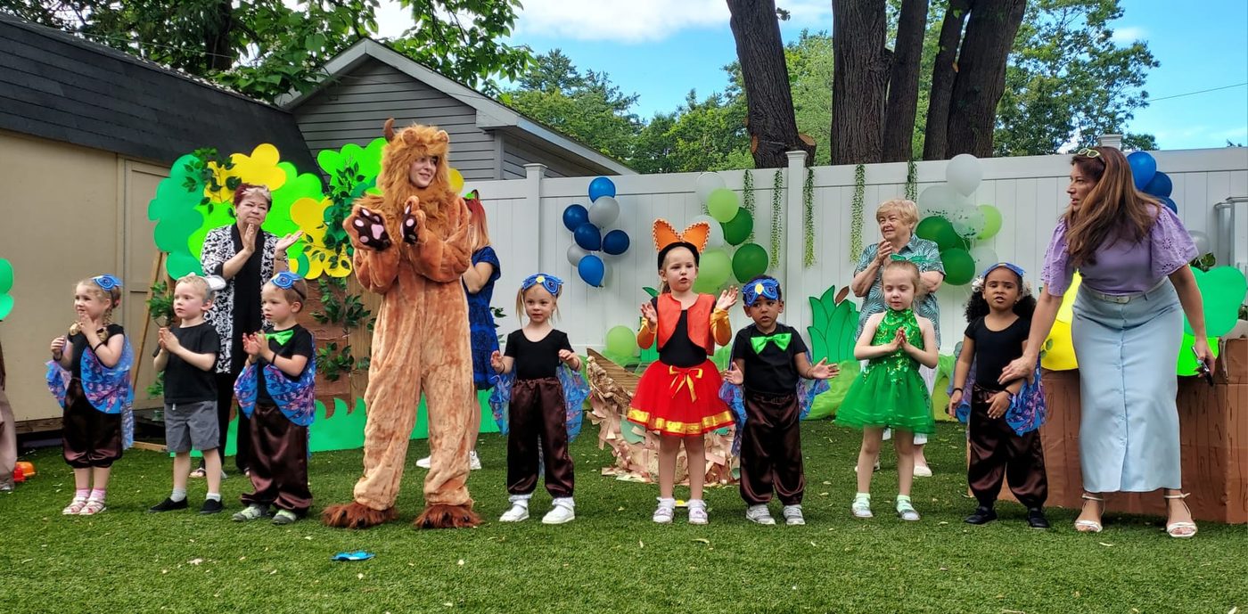 Children in costume performing outdoors at Tot Family Daycare