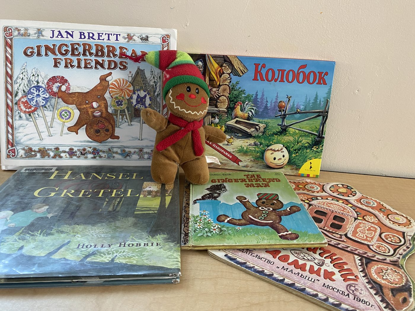 English and Russian children's books with a gingerbread man plush toy