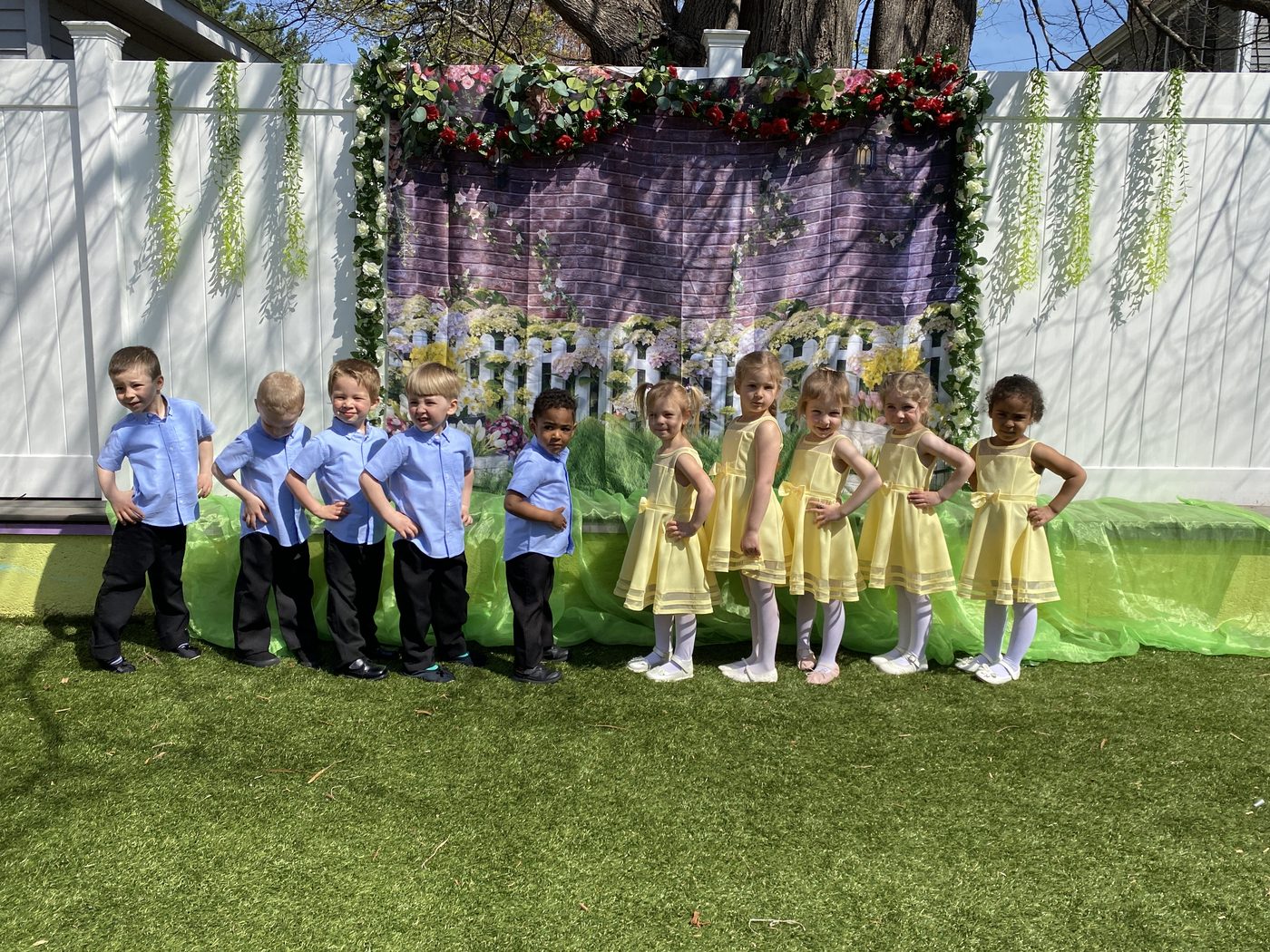 A group of children posed together in matching outfits at the daycare